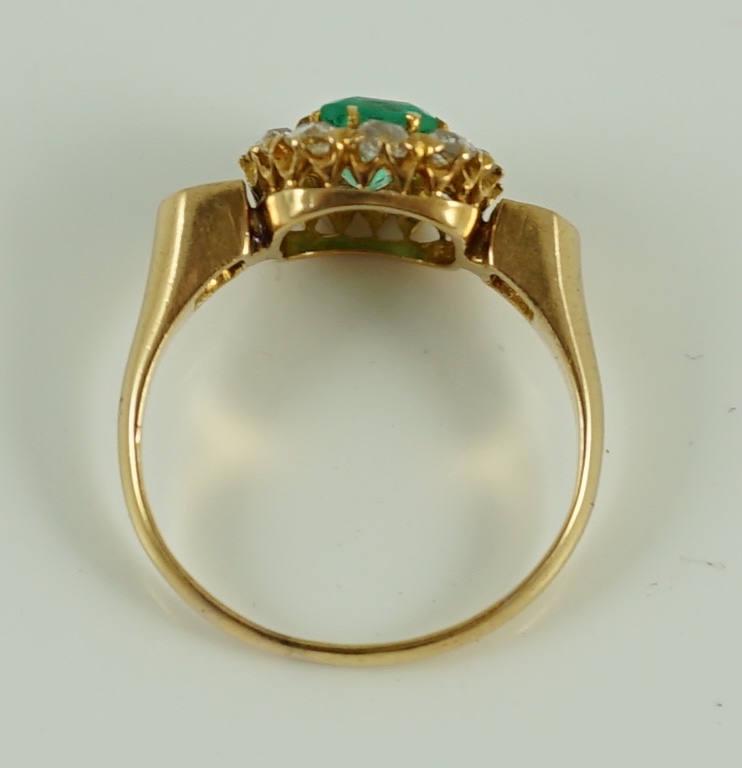 An 18ct gold, emerald and diamond octagonal cluster ring